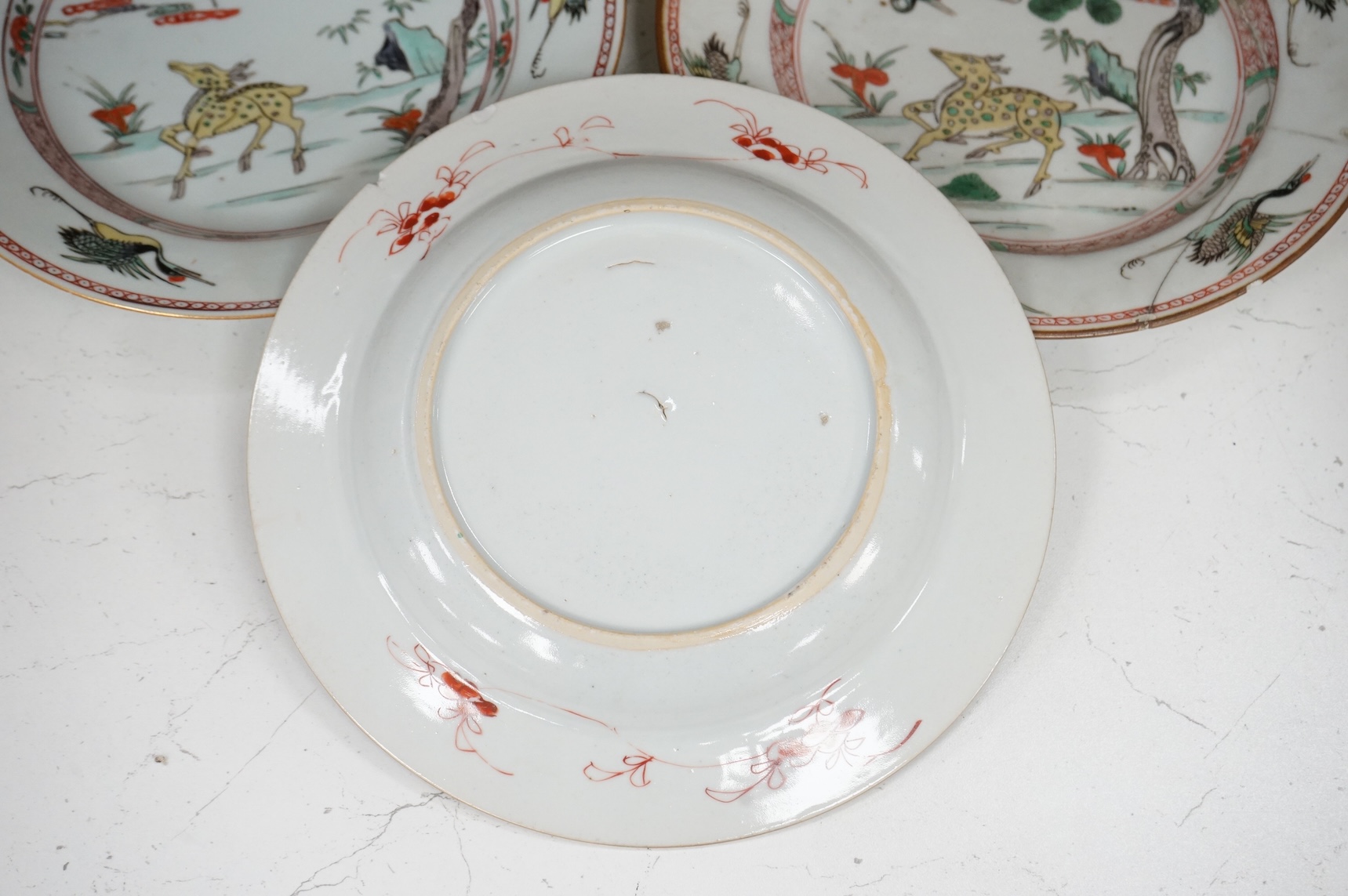 Three Chinese famille verte deer and crane plates, Kangxi period, 22cm in diameter